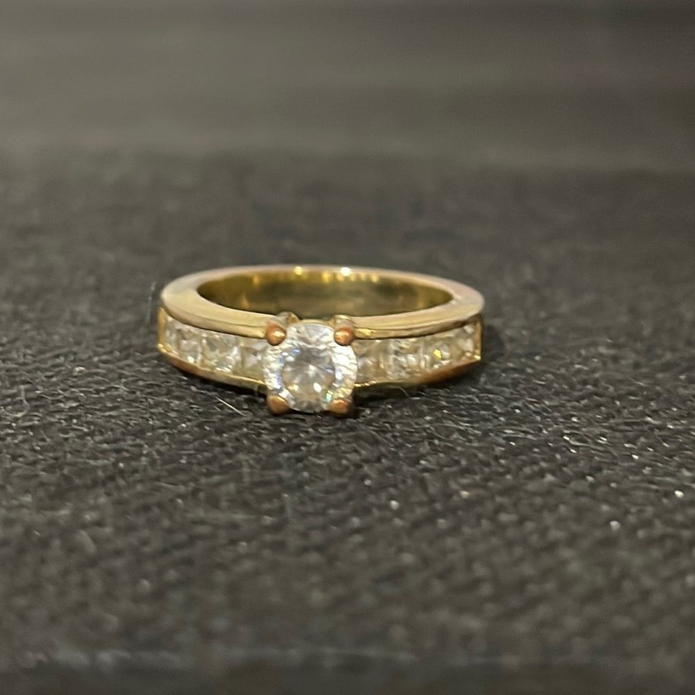 Ring with one large white gem and several next to it